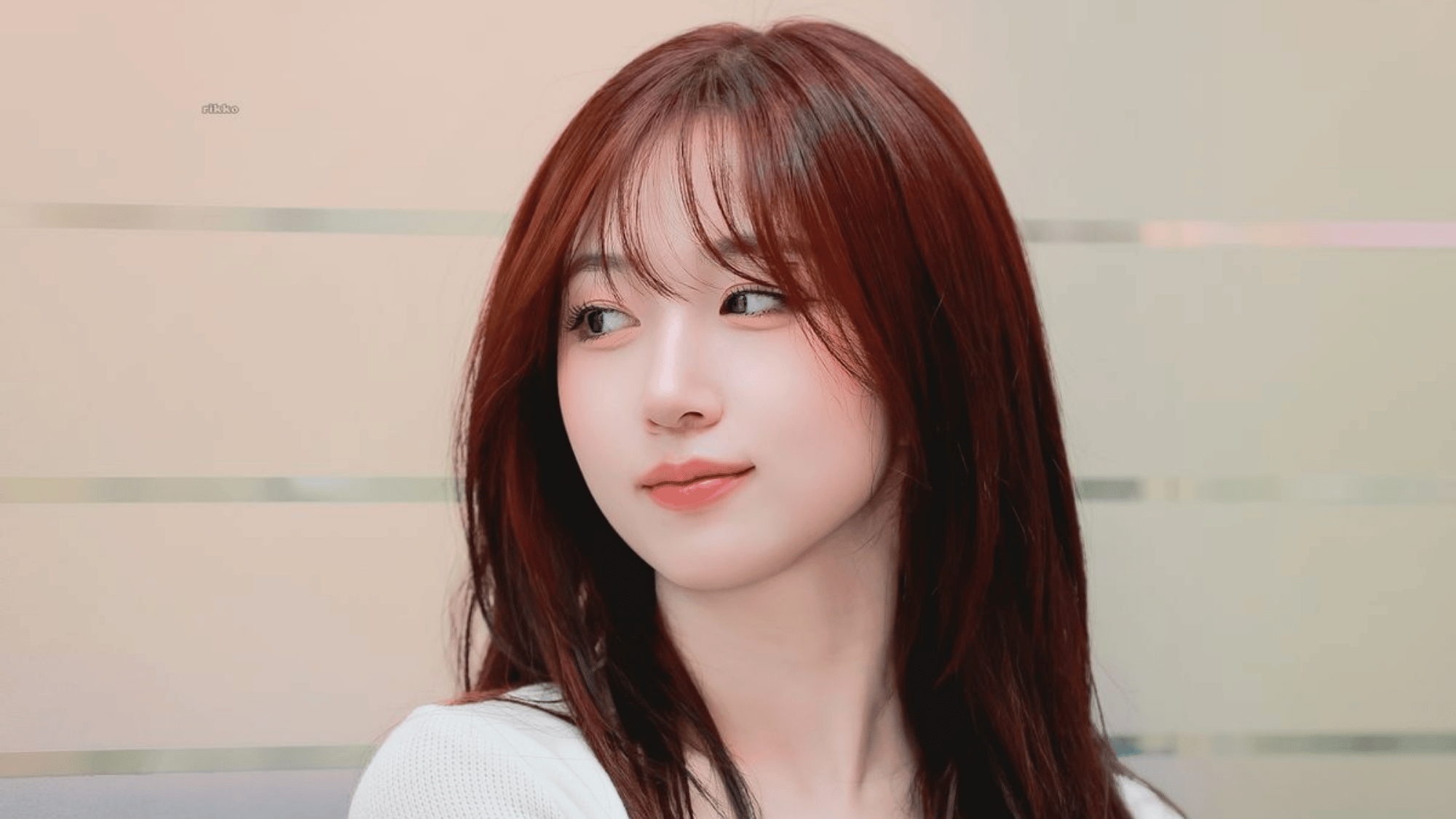 KiiiKiii member Haum with reddish brown hair and soft side bangs