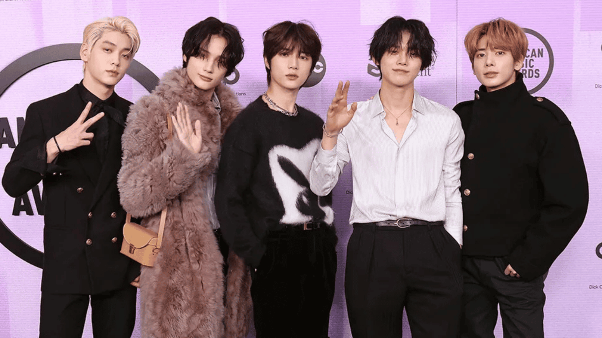 TXT members posing together, showcasing their individual styles and appearances in a group photo