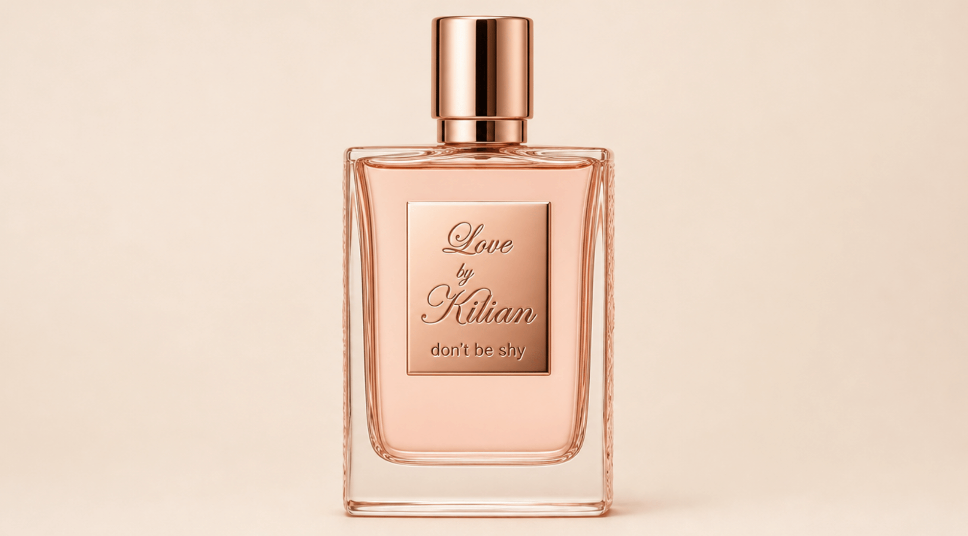 Love Don't Be Shy perfume bottle by Kilian with rose gold cap on a soft beige background