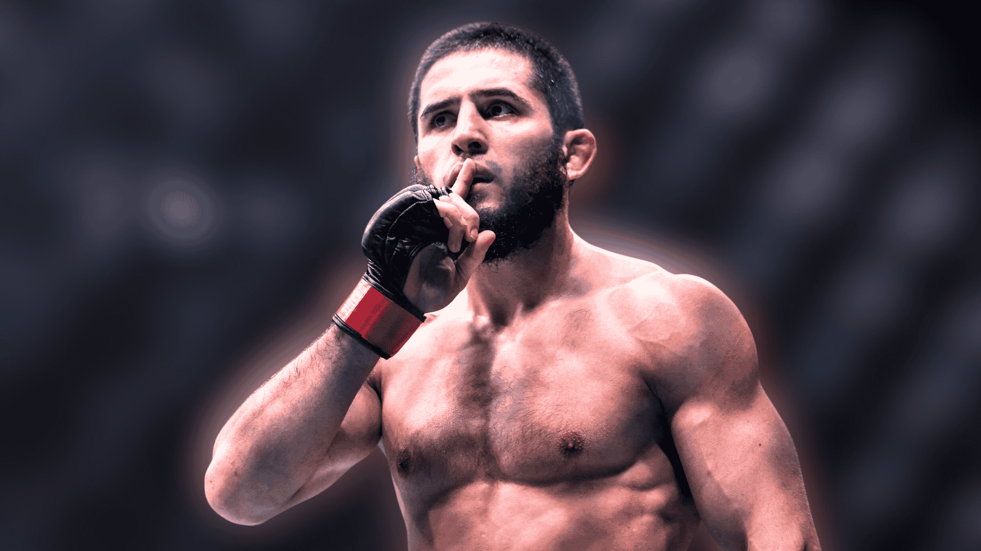 islam makhachev standing inside the octagon with one finger raised to his lips