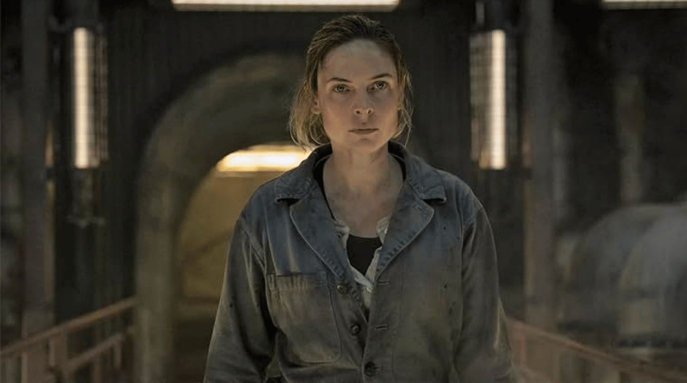 Juliette Nichols standing in a dim industrial tunnel.