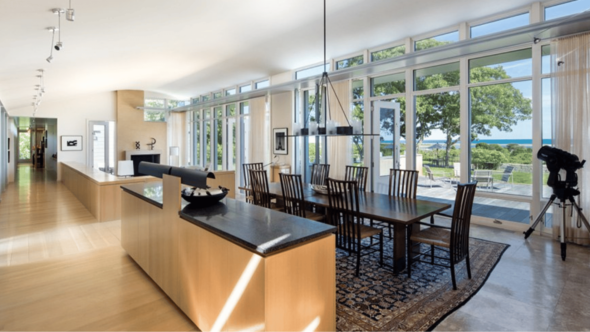 kitchen and dining area in obama marthas vineyard home with open layout large windows ocean view modern furnishings airy