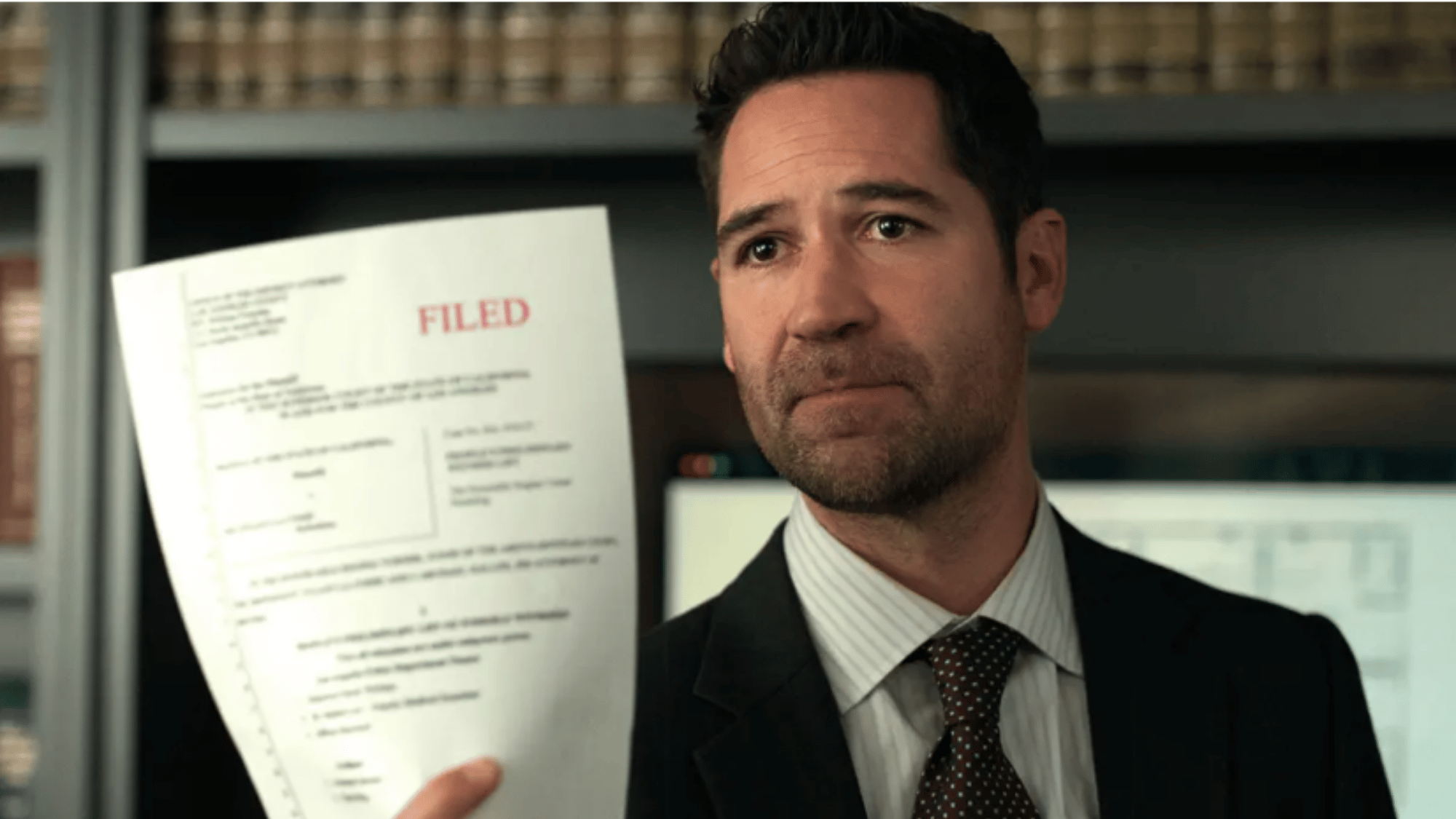 Attorney holding a filed legal document in an office, highlighting a key courtroom case development.