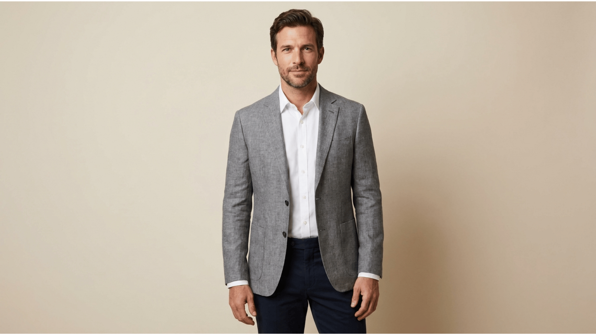 man wearing a lightweight suit jacket with a white shirt at a summer wedding venue