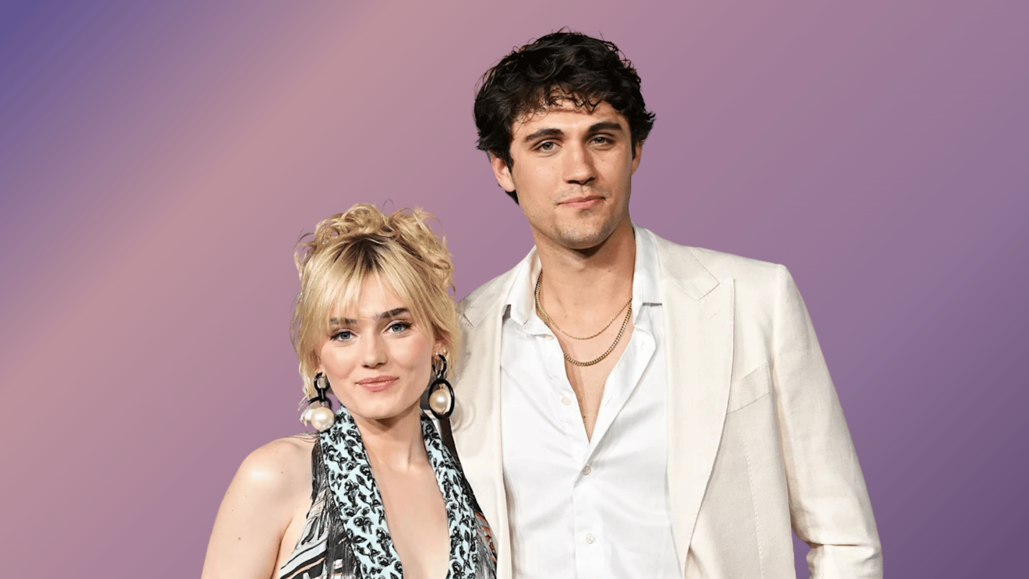 Meg Donnelly and Drake Rodger pose together in stylish outfits, smiling at a public event backdrop.