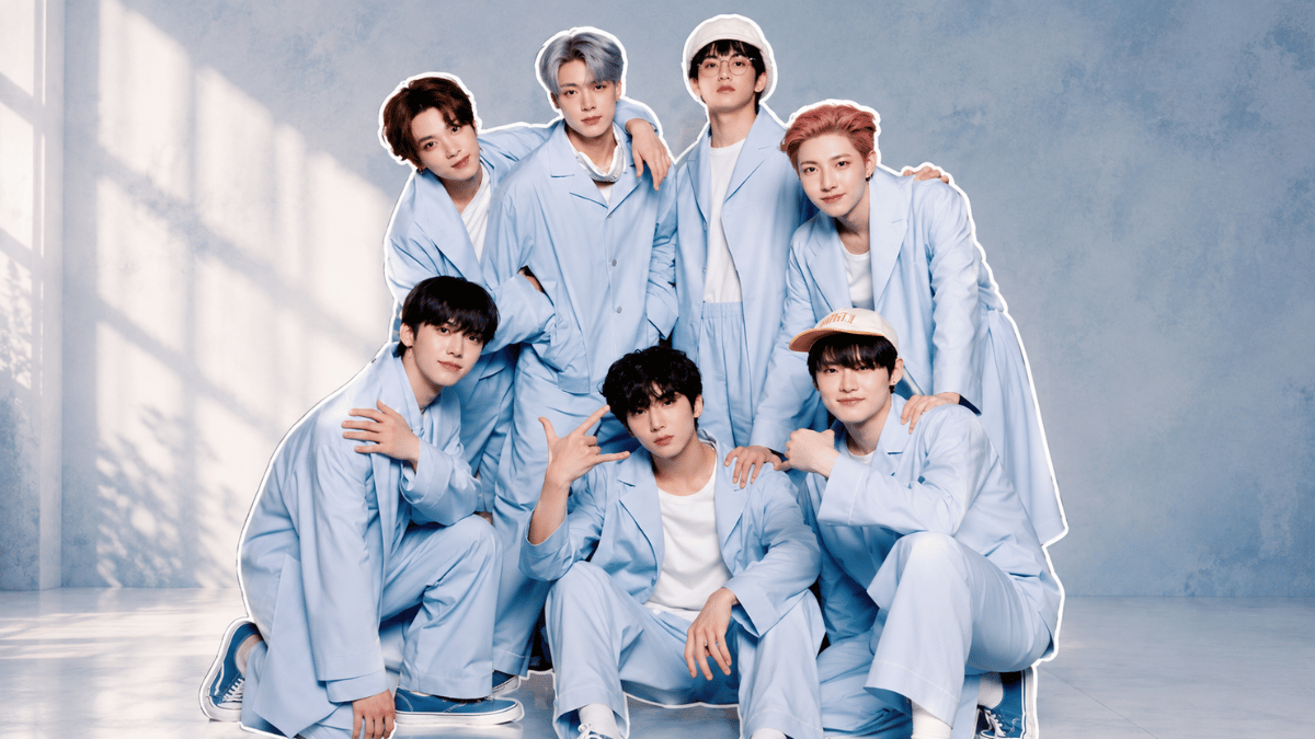 NCT members posing together in coordinated light blue outfits during a promotional group photoshoot showcasing the K-pop group's lineup.