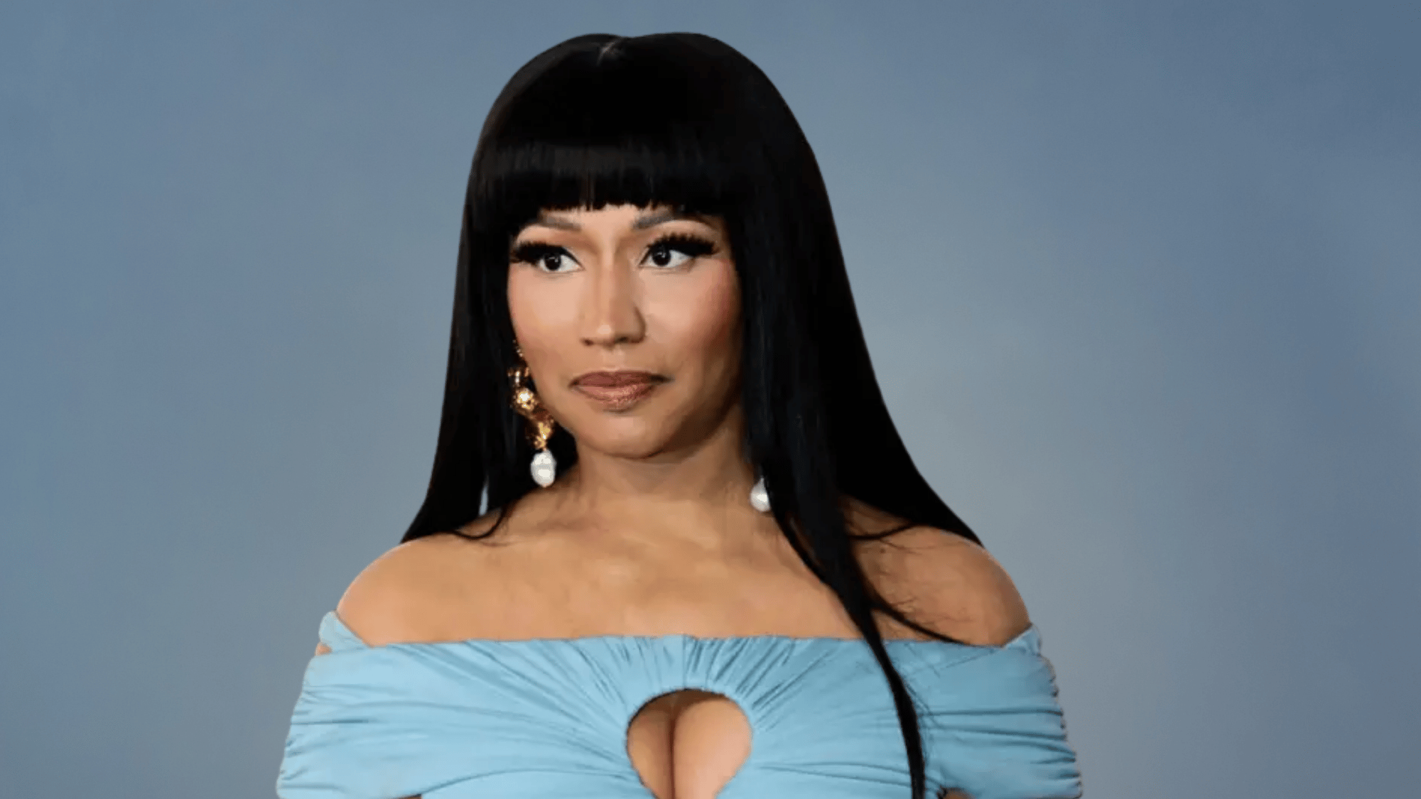 Nicki Minaj posing for a professional portrait against a light backdrop.