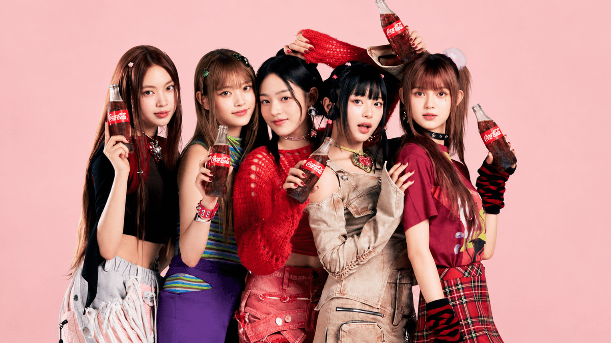 newjeans members posing in elegant outfits on a pastel pink background