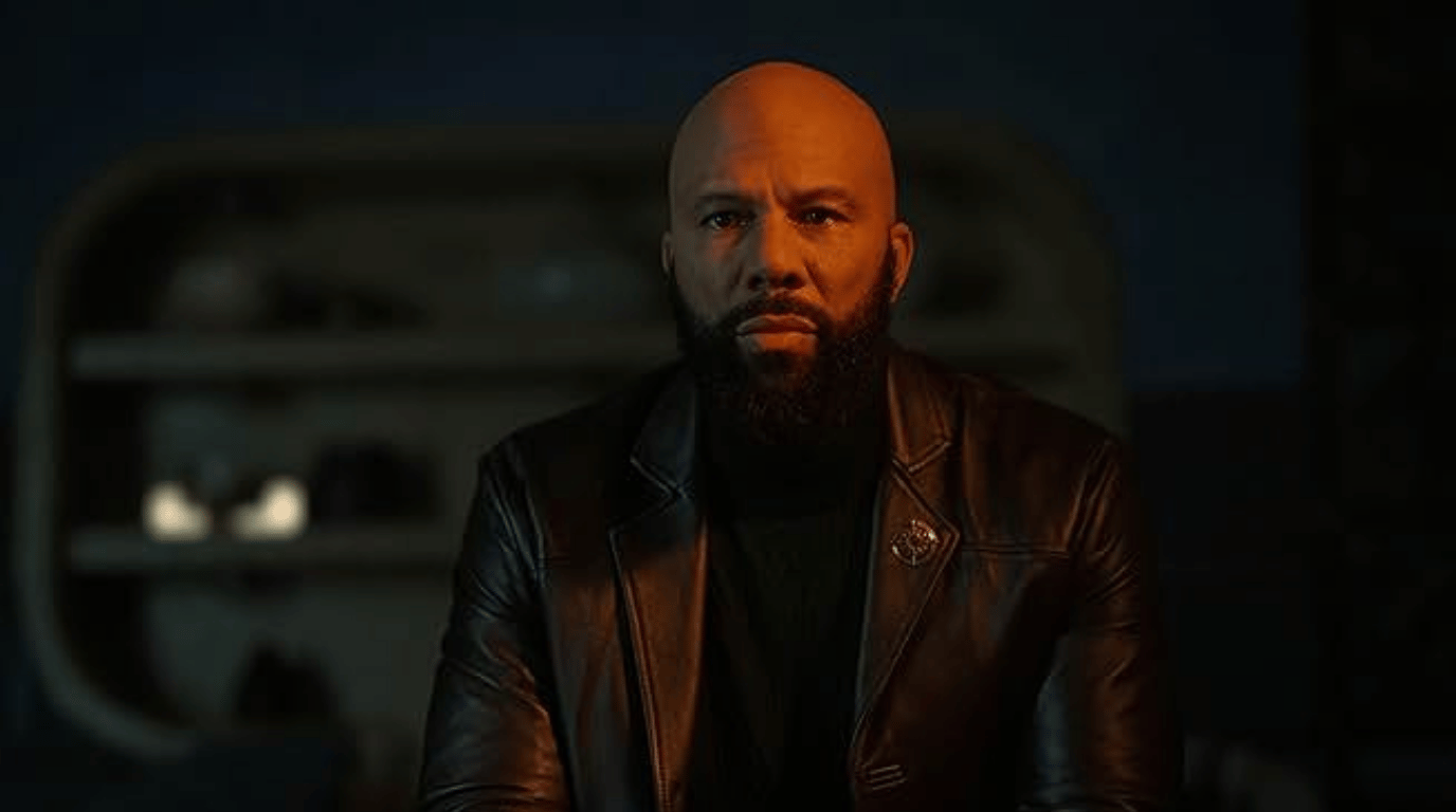 Robert Sims in a leather jacket under warm dim lighting.