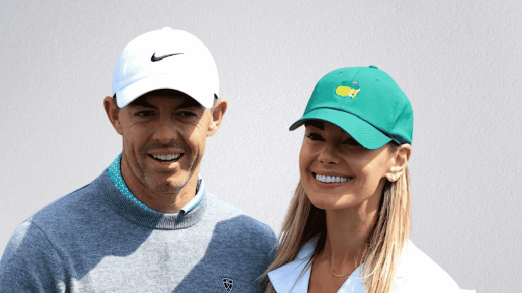 Rory McIlroy in a white Nike cap and Erica Stoll in a green Masters cap, smiling together.