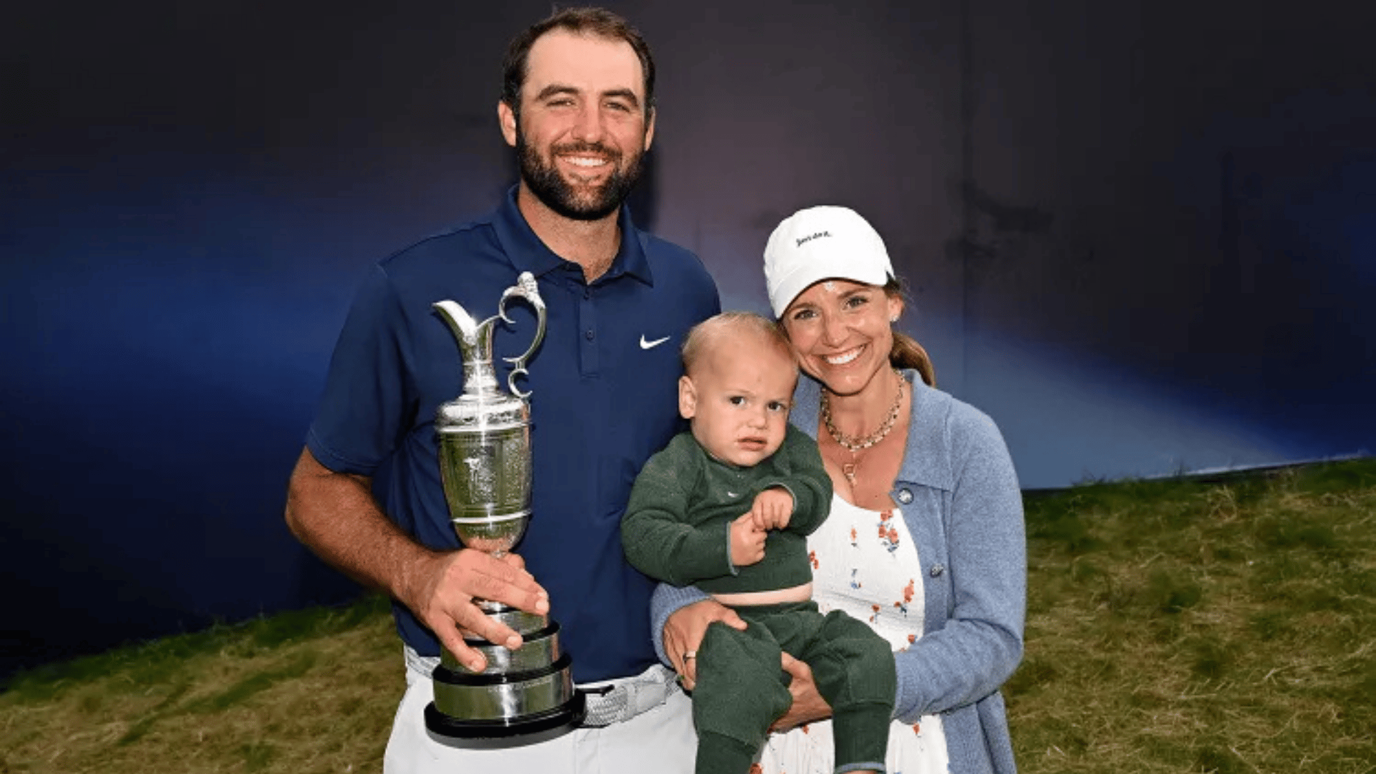 scottie scheffler with meredith scudder and son holding championship trophy
