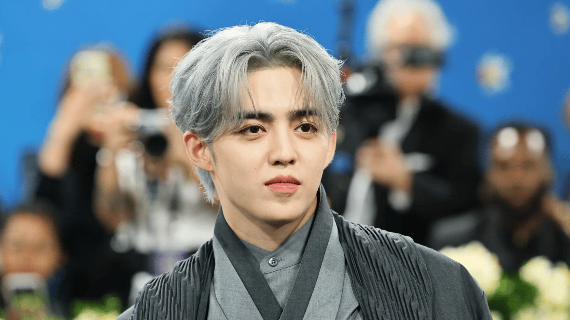 S.Coups of seventeen posing for a portrait in a outfit with a calm expression
