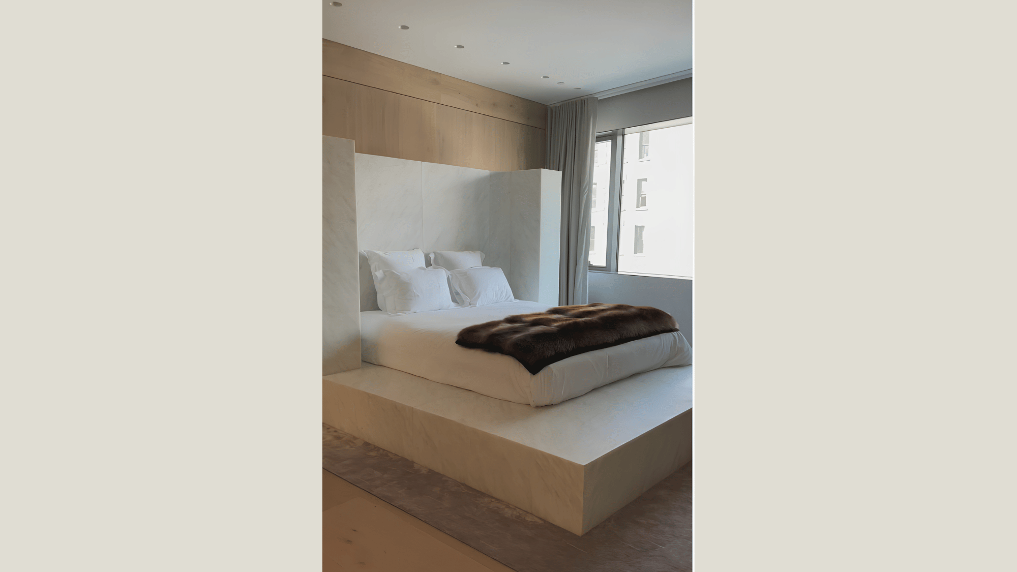 minimalist bedroom with a platform bed, soft neutral palette, natural materials, and large windows for a calming retreat.