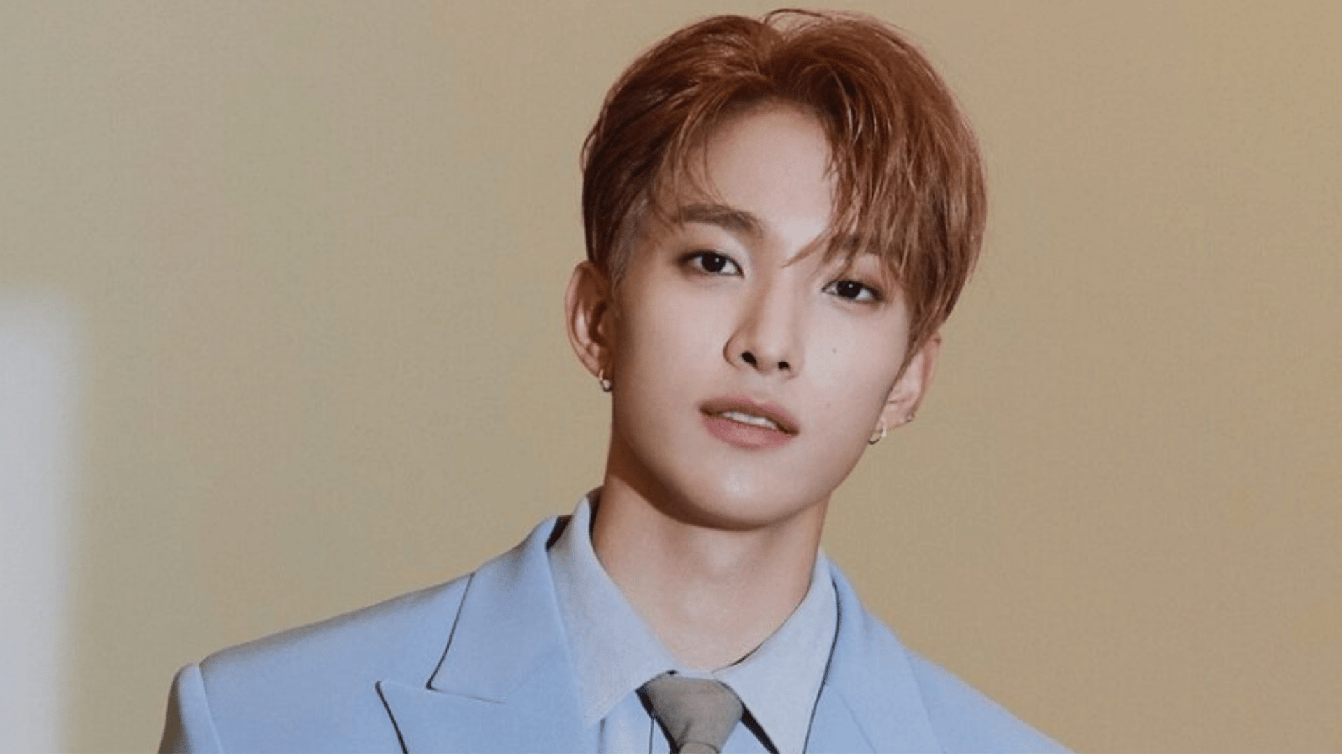 Seungkwan of seventeen posing for a portrait with a warm and cheerful expression