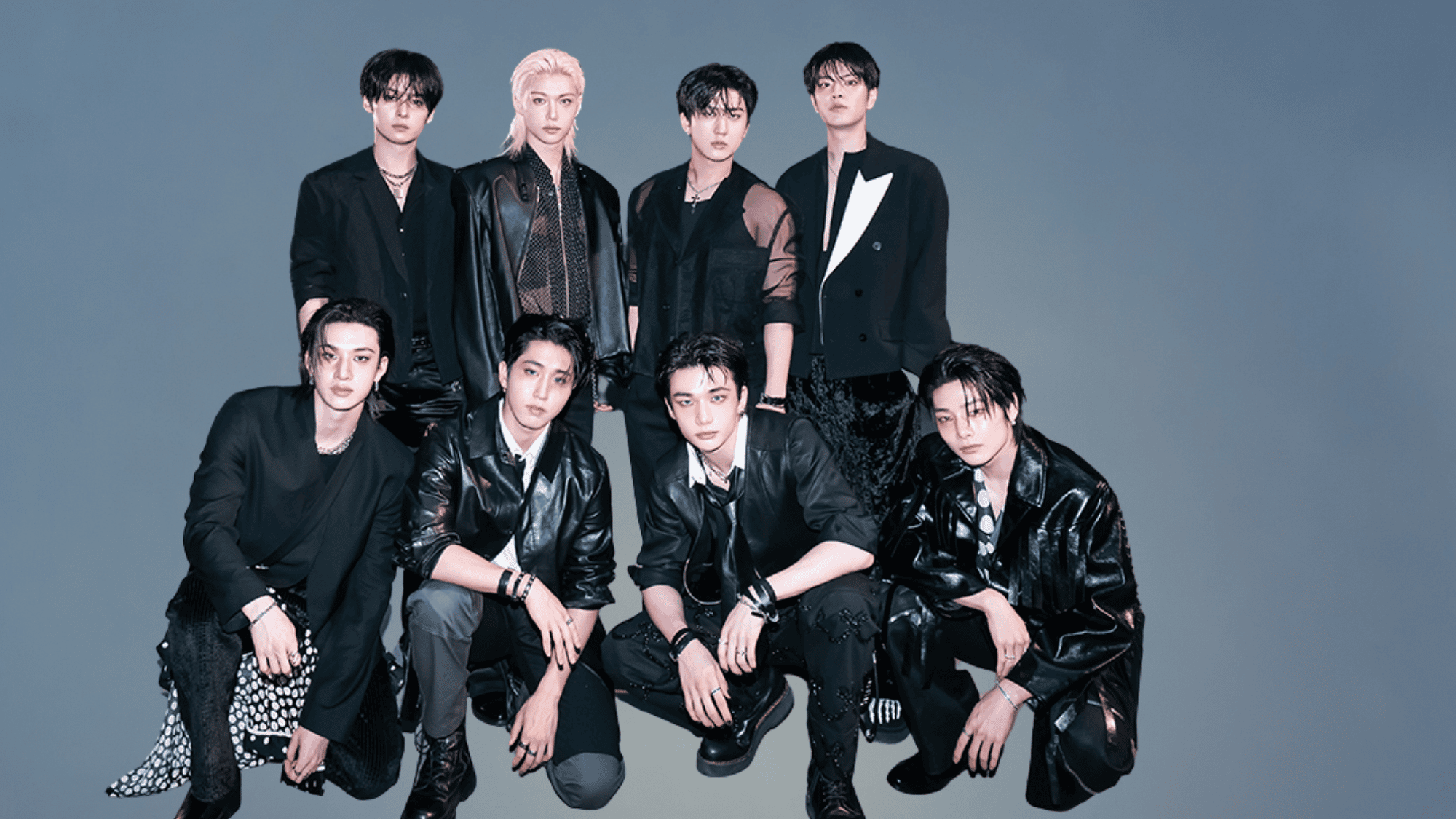 A group photo of the K-pop boy band Stray Kids posing together.
