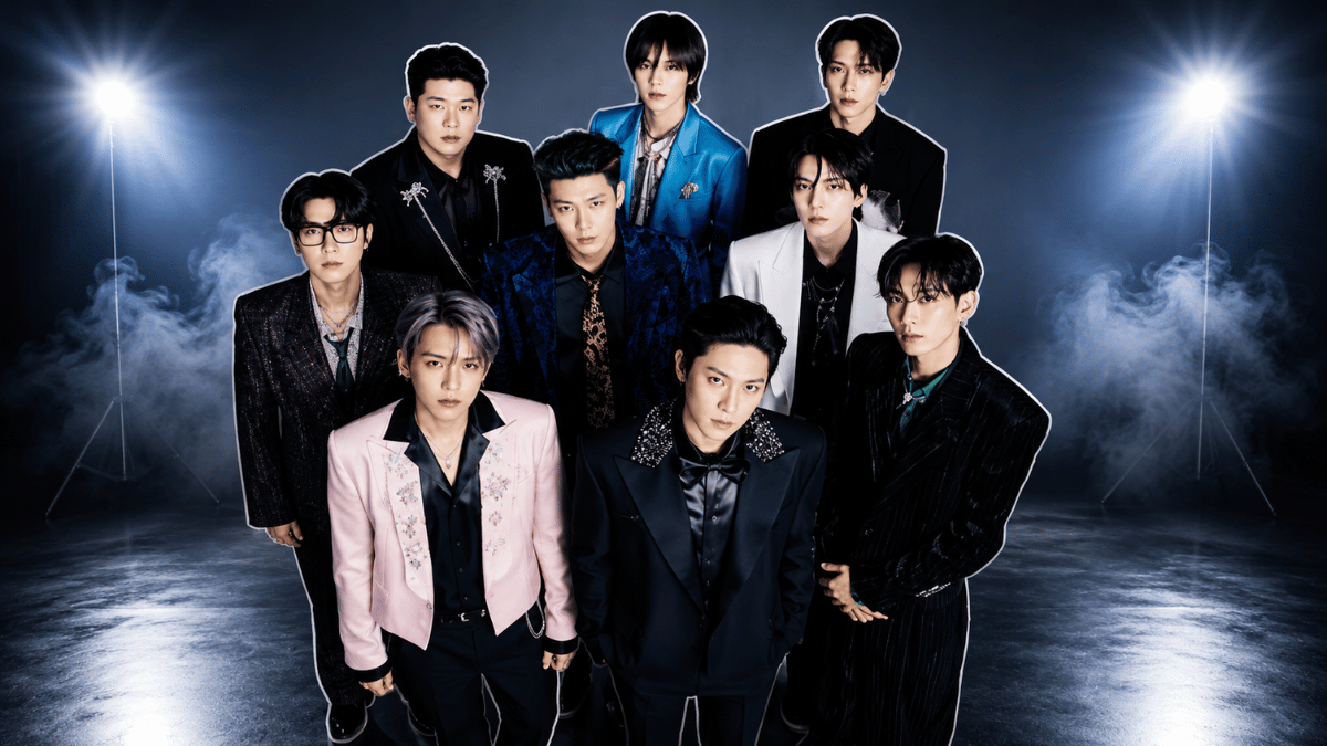 Super Junior posing in formal outfits with a dramatic studio backdrop
