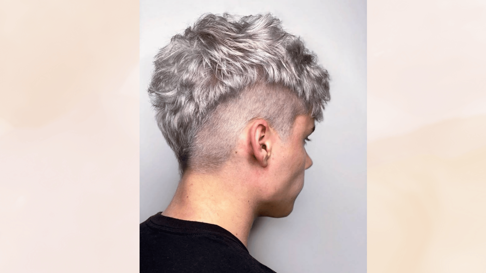 textured mohawk haircut with layered volume and faded sides creating a modern relaxed stylish appearance