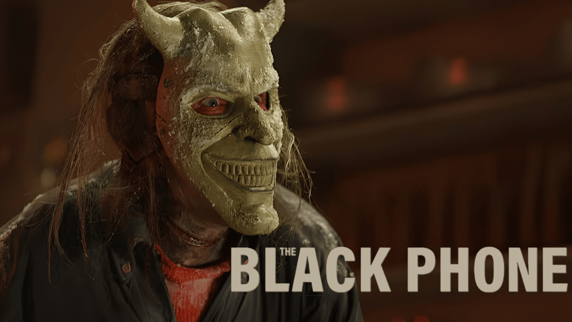 The Grabber wearing his eerie mask in The Black Phone movie, highlighting the film's chilling horror atmosphere.