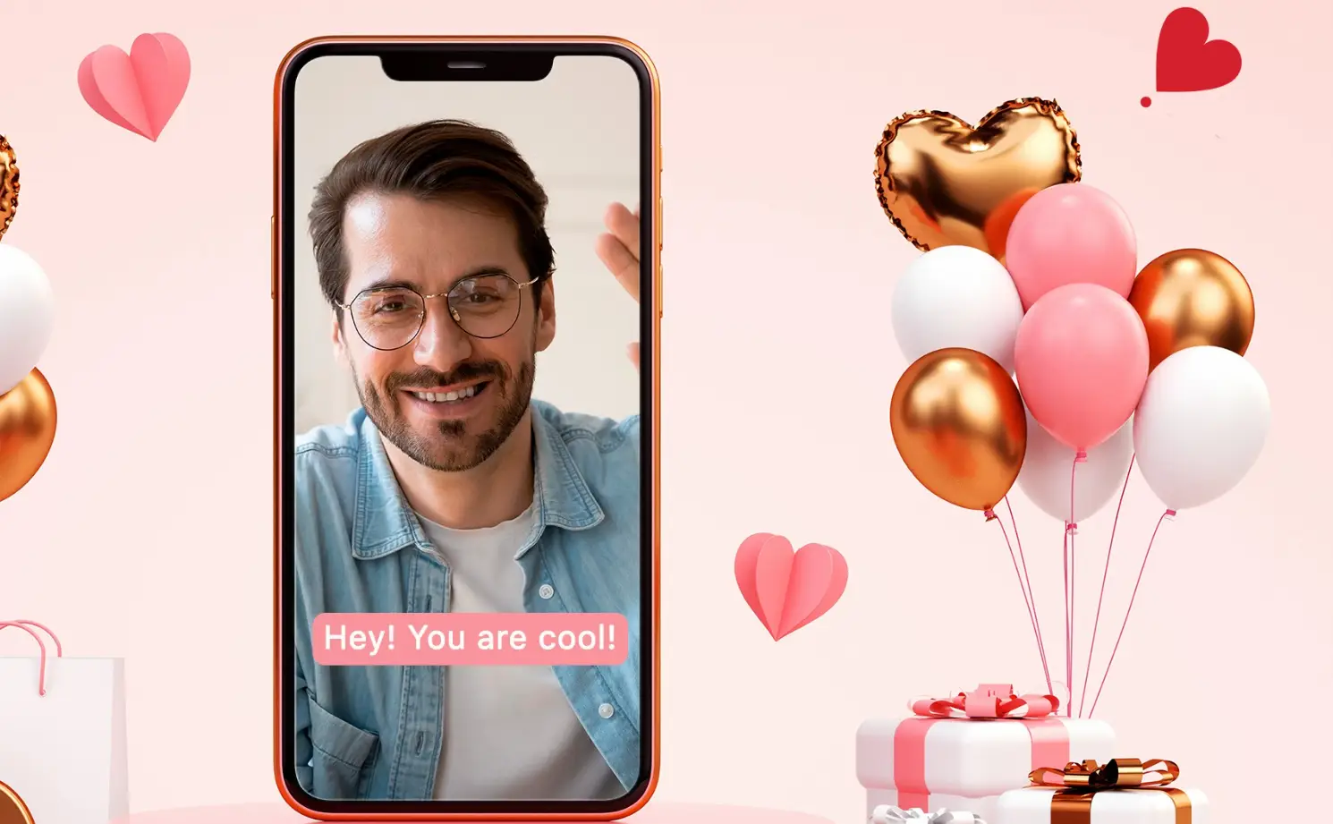 Smartphone displaying smiling man with balloons and gift boxes against pink background