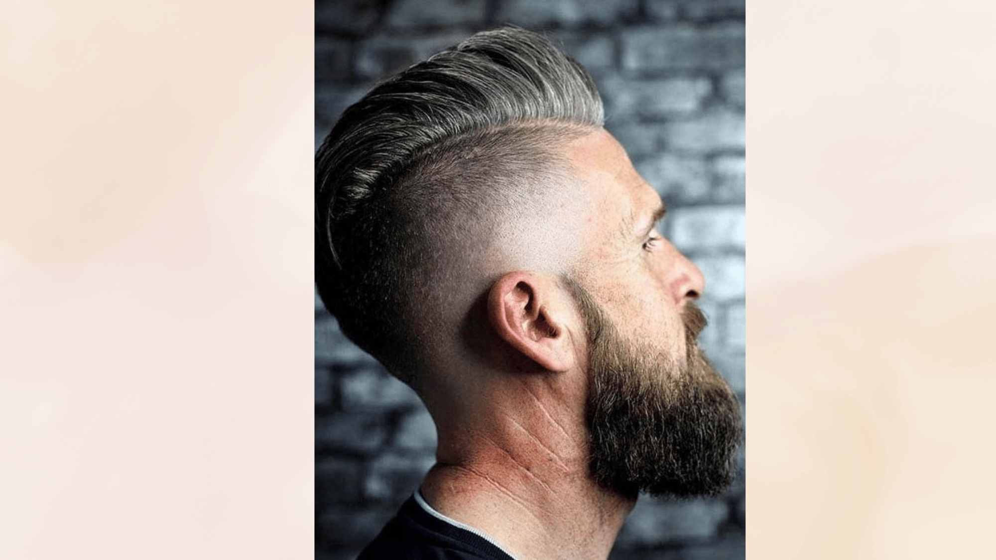 viking mohawk hairstyle with slicked back top, shaved sides, full beard, and bold masculine style look