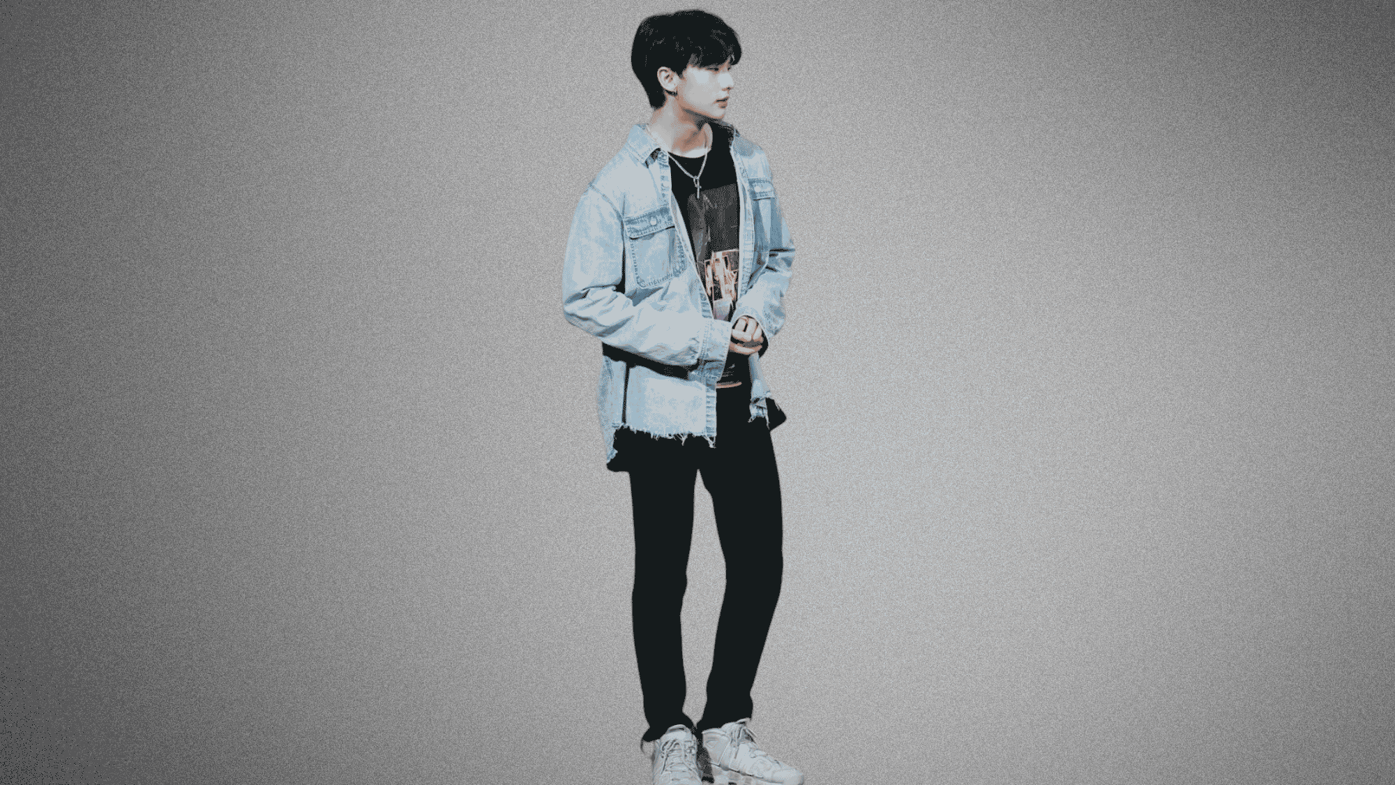 Hyunjin full-body photo in denim jacket and black pants against a gray studio backdrop
