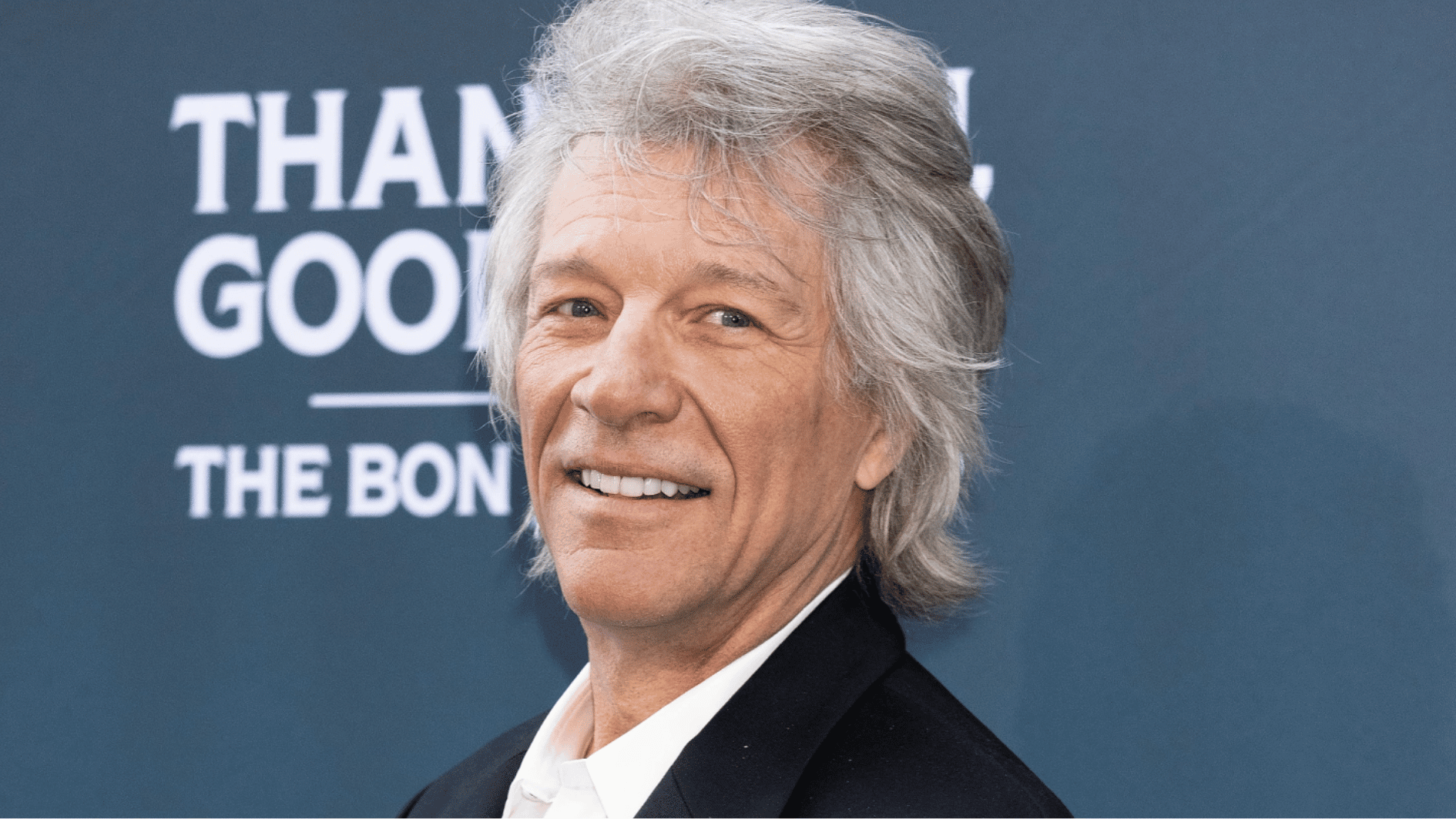 jon bon jovi smiling during a public appearance, showing he is healthy and active amid false death rumors