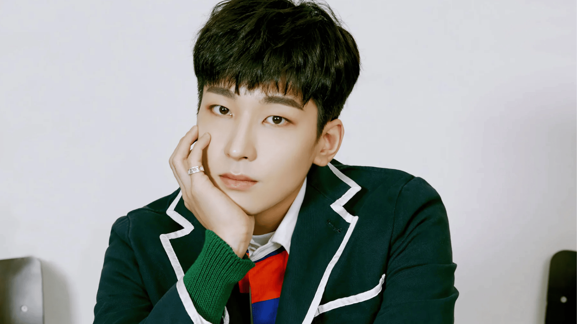 Wonwoo of seventeen looking calm in a close-up portrait with a fashionable outfit