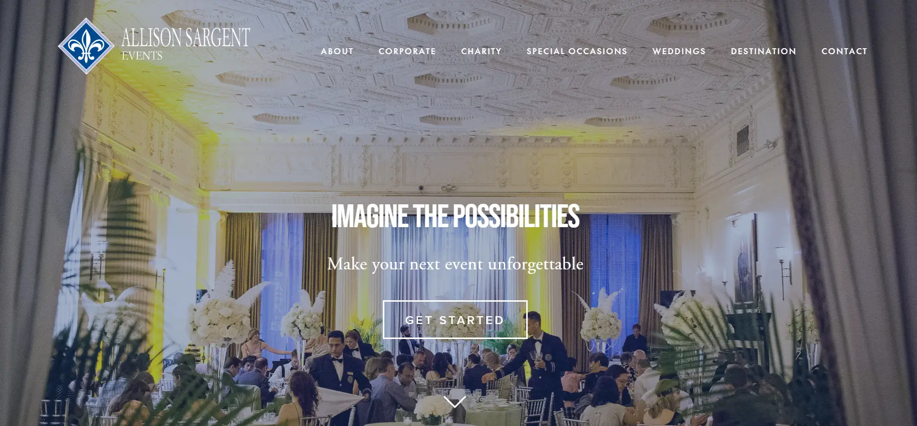 Elegant event with guests seated at decorated tables in lavish hall with ornate ceiling