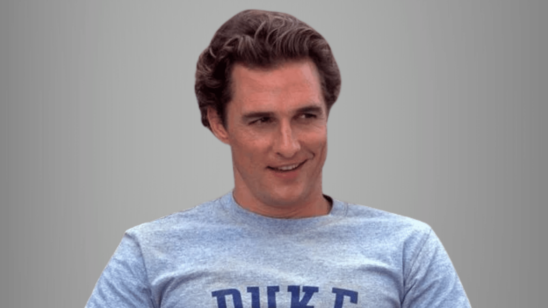 Matthew McConaughey smiling during an interview in a blue T- shirt