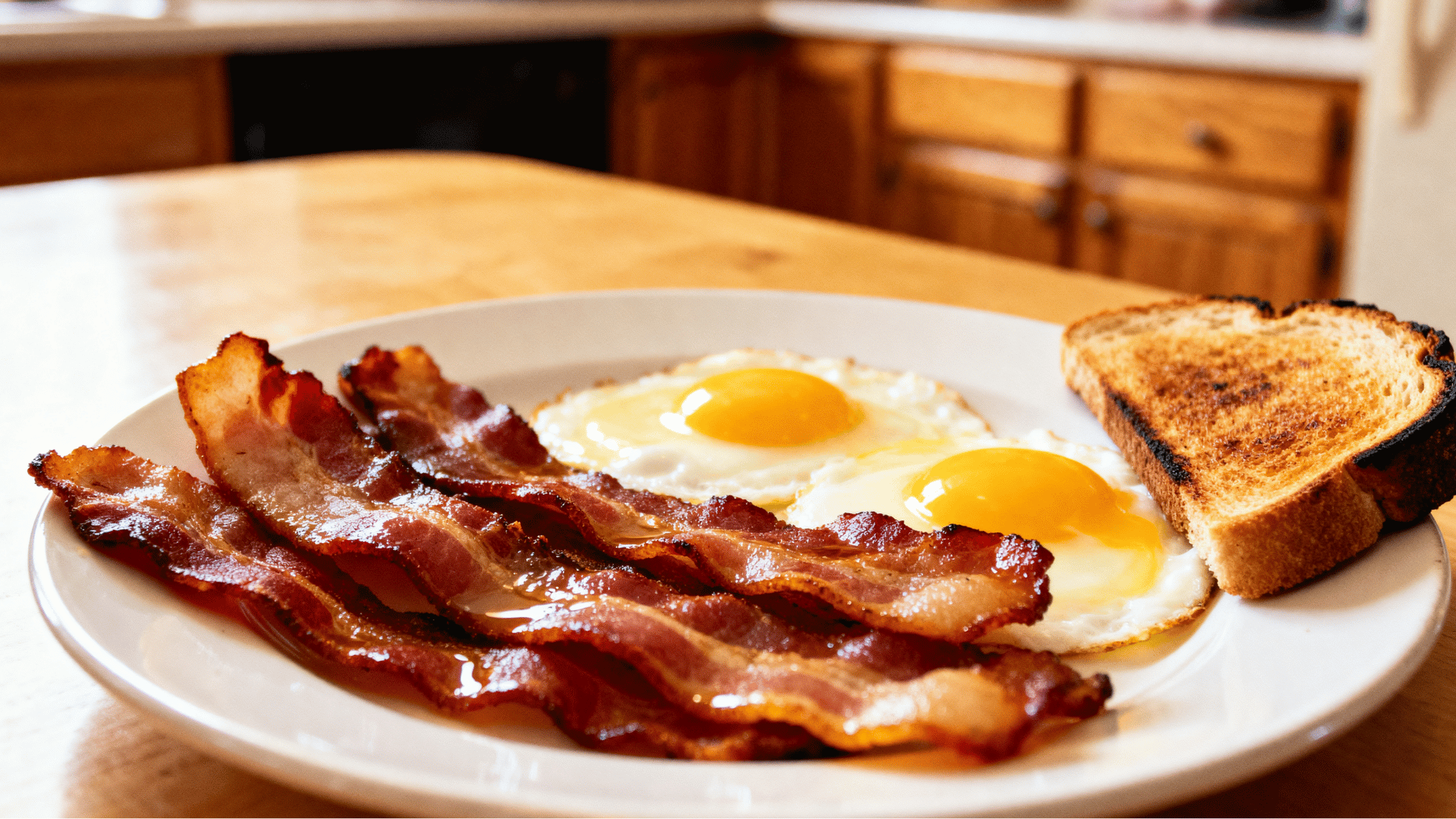 crispy bacon slices on a breakfast plate with eggs and toast showing <echighlighted><echighlighted><echighlighted>bacon nutrition facts</echighlighted></echighlighted></echighlighted> and serving ideas