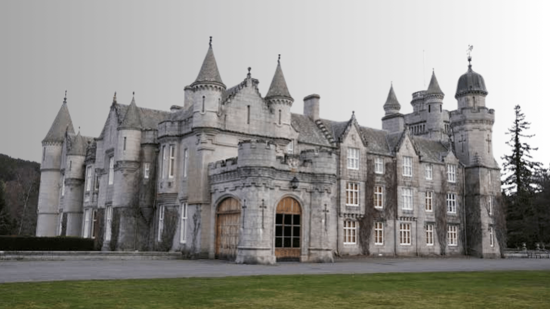 Balmoral Castle with stone towers and surrounding grounds in Scotland