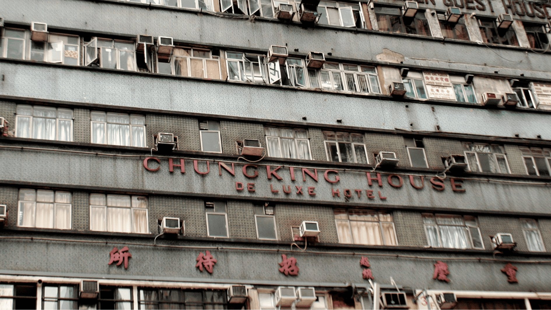 chungking mansions exterior showing its historic hong kong building facade with old windows and air conditioners