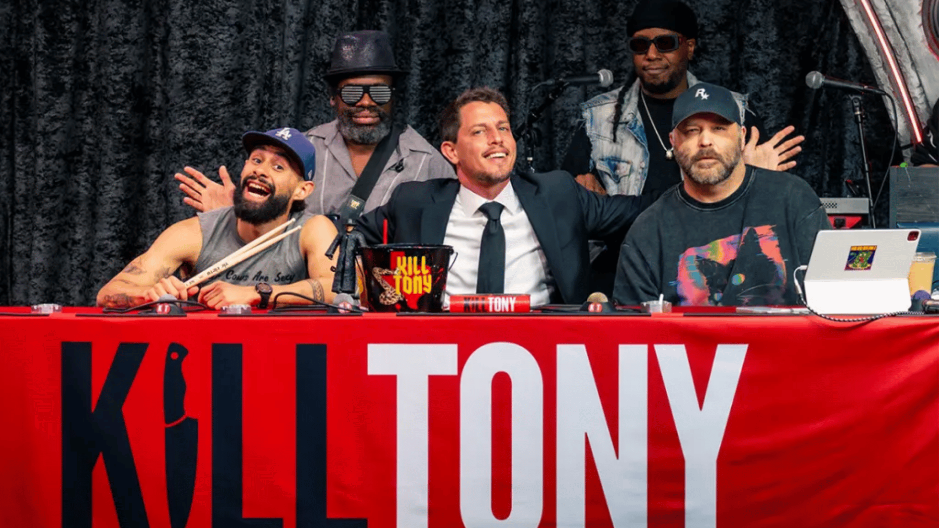 tony hinchcliffe seated with guest comedians during a live kill tony podcast event