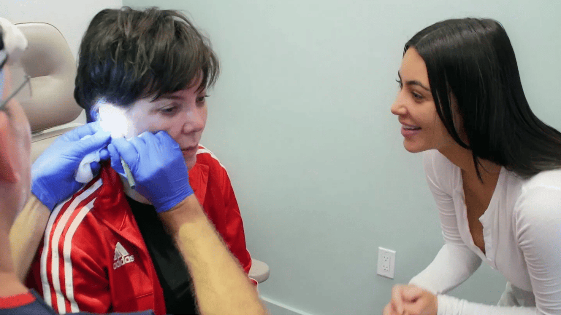 Kris Jenner undergoes an earlobe reduction procedure during a reality television segment.
