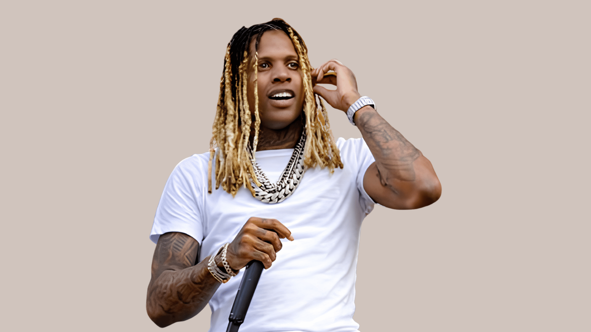 Lil Durk performing on stage in a white outfit