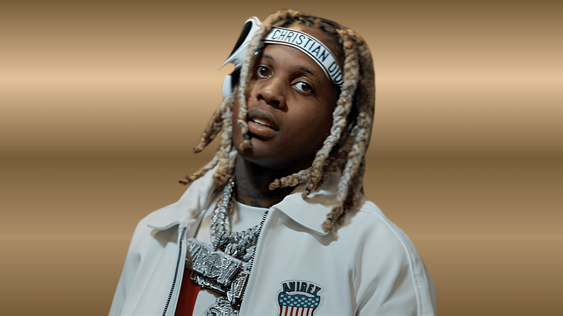 Lil Durk posing with jewelry and stylish streetwear