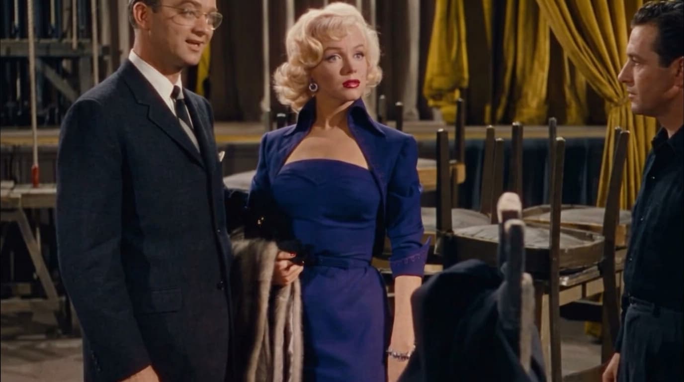 marilyn monroe in a soft pastel blue off shoulder dress posed in an elegant mid century interior setting