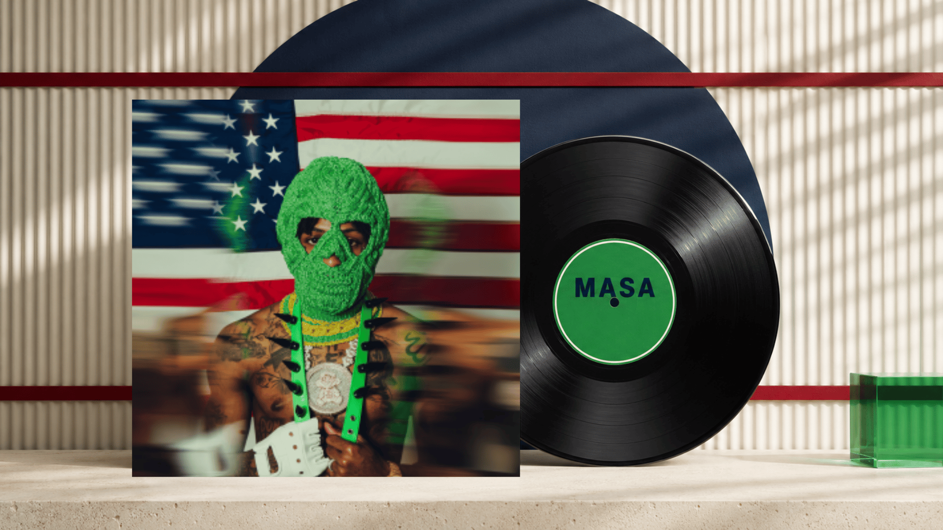 masa album cover beside a black vinyl record with a green center label