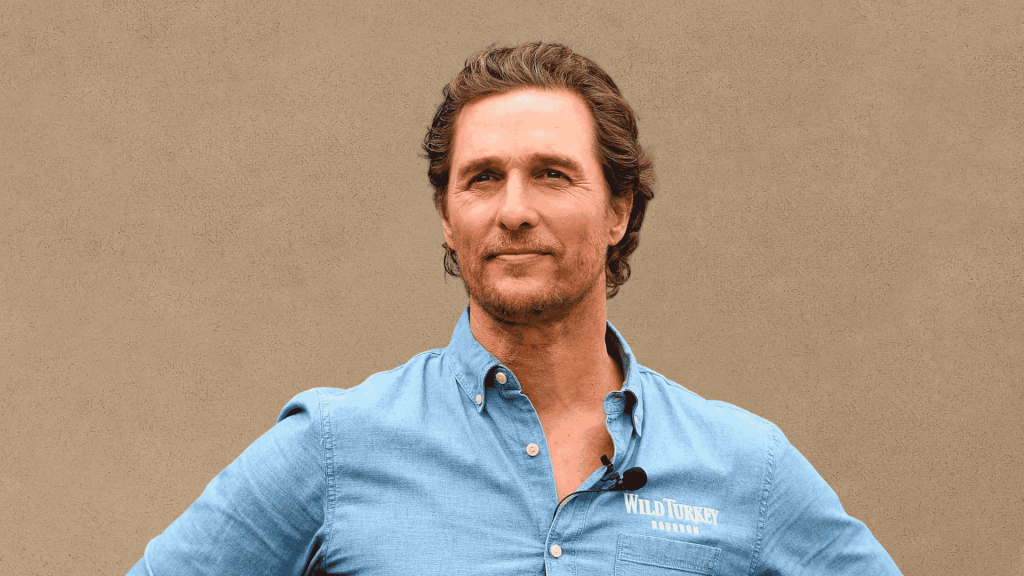 Matthew McConaughey posing in a blue shirt for a brand appearance