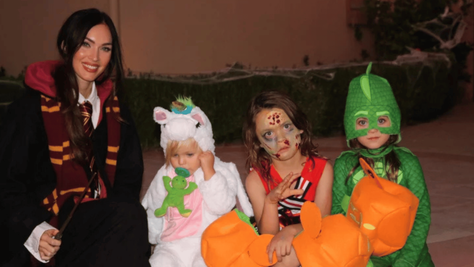 megan fox and her kids in halloween costume at night