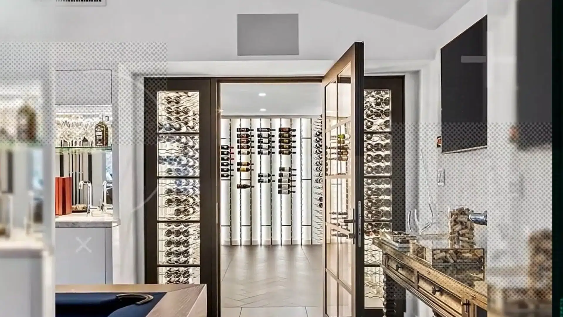 modern kitchen opening into a bright wine cellar with extensive bottle storage and glass cabinets