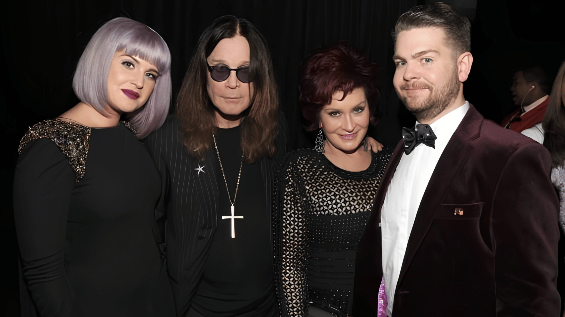 Ozzy Osbourne with Kelly, Sharon, and Jack Osbourne at a formal event.