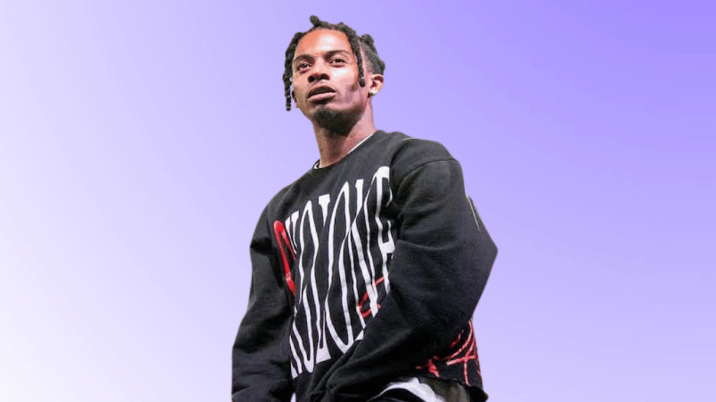 Playboi Carti performing in black outfit during a concert appearance