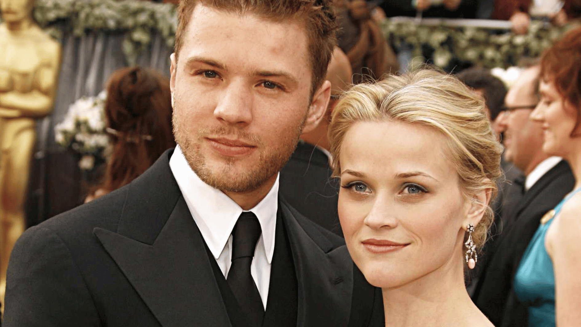 reese attending a film festival with ryan wearing a black tuxedo and posing in the camera and are smiling