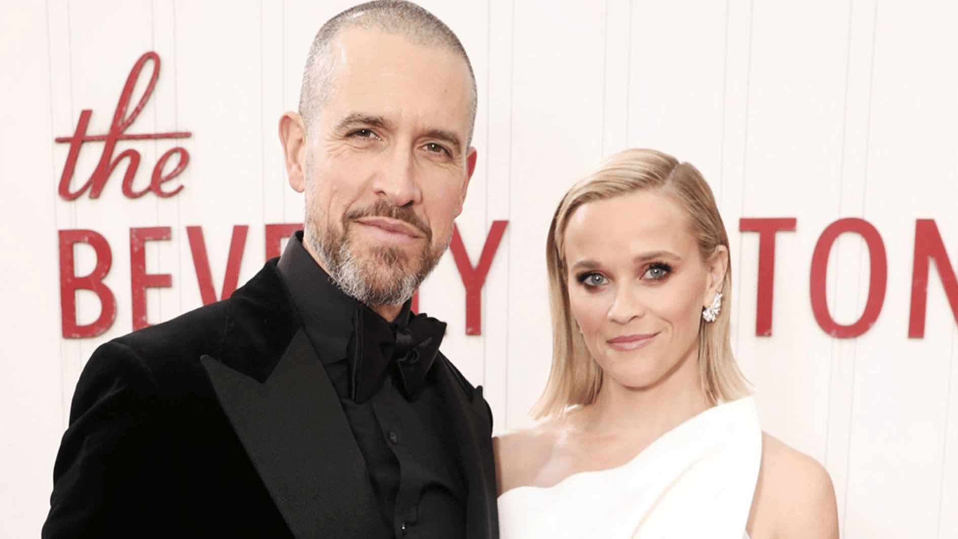 reese witherspoon posing with jim in a black tuxedo at a formal beverly hills event