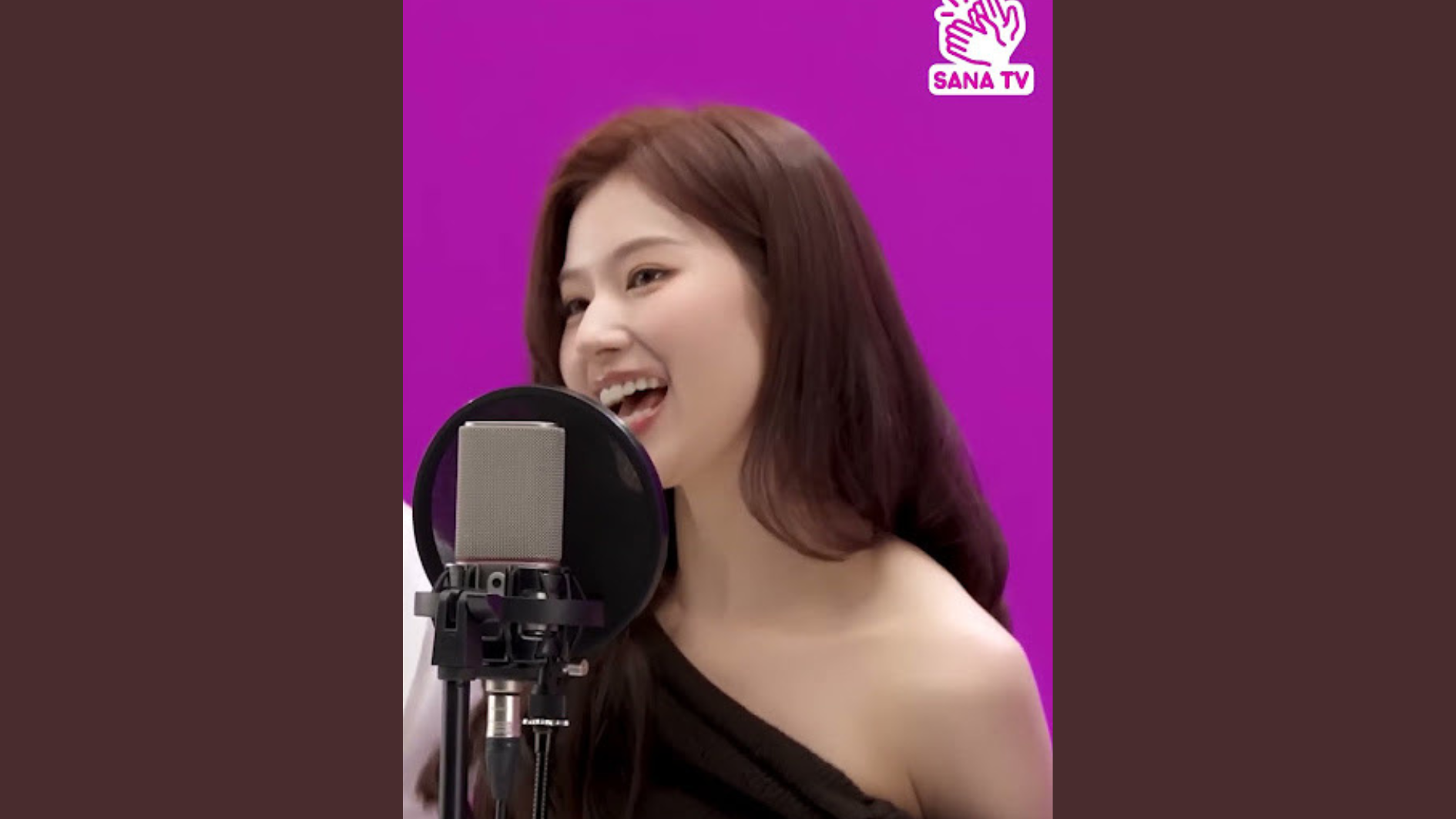 sana singinh in front of a mic