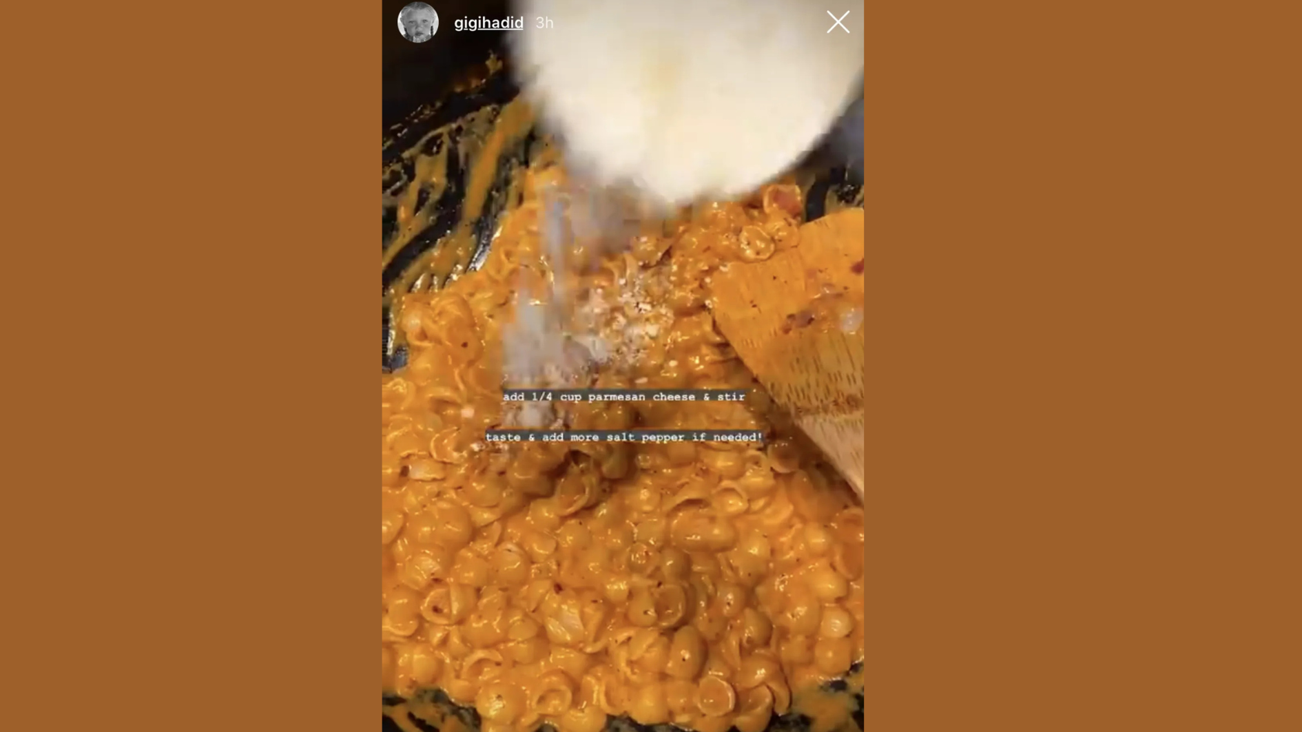 parmesan being added to creamy gigi hadid pasta in a pan