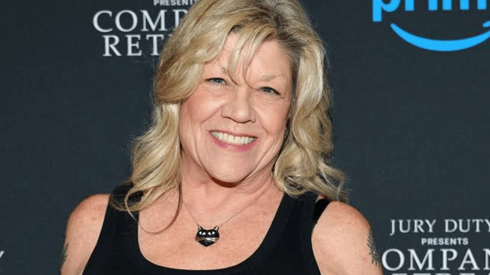 stephanie in a black sleeveless top posing at a jury duty presents company retreat event