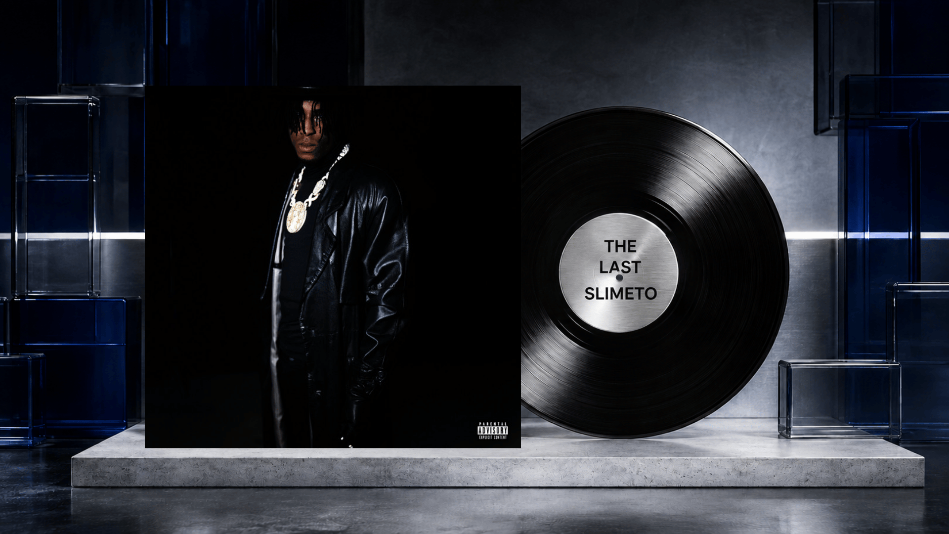 the last slimeto album cover beside a black vinyl record on a dark blue set