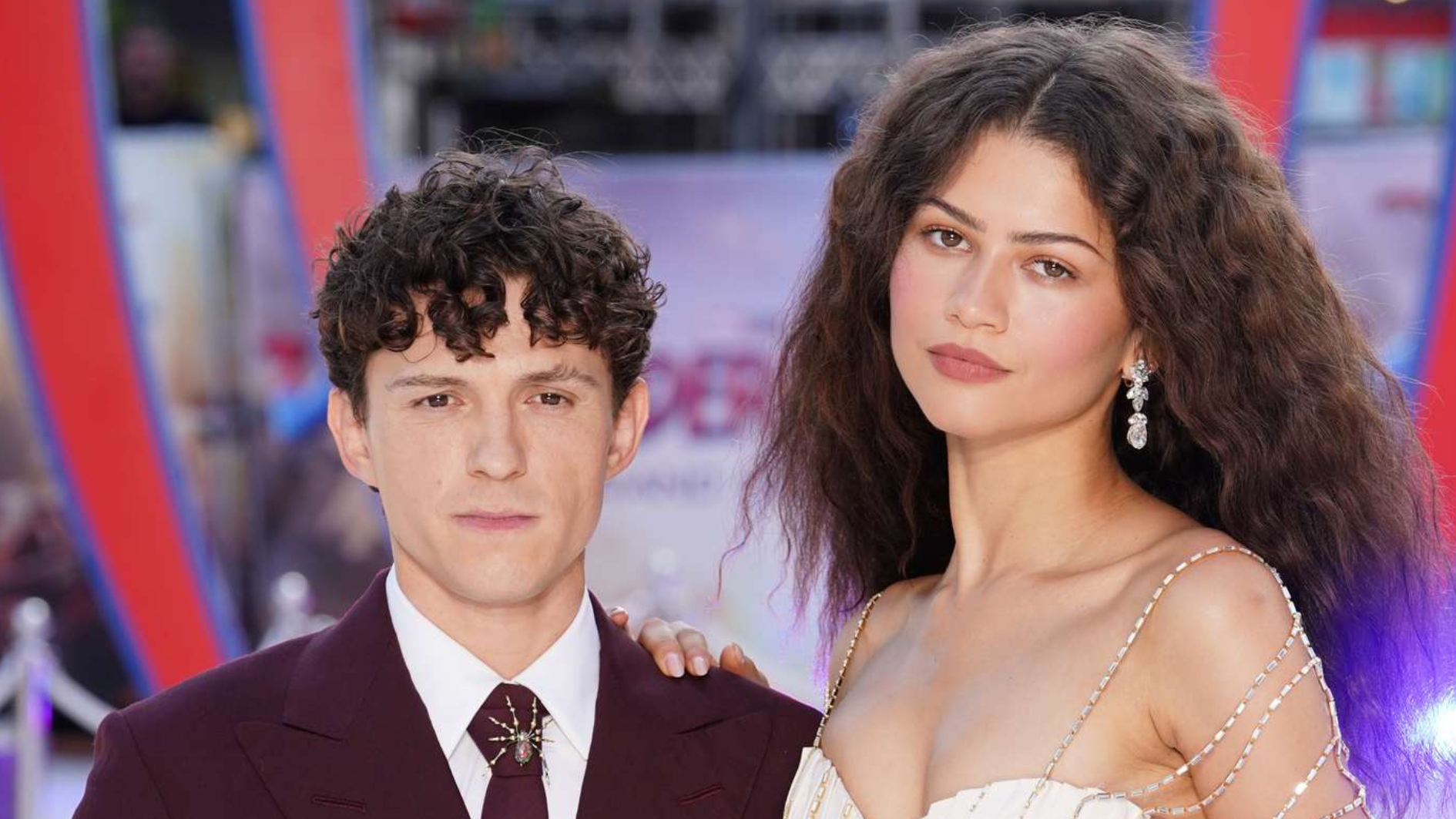 tom holland standing beside zendaya at a film premiere